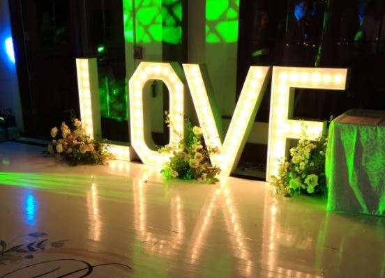 Toronto letter lights that decorating the dancefloor at a wedding 