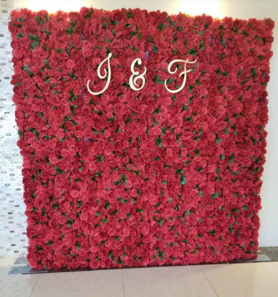 Spring wedding in Montreal with red flower wall. 