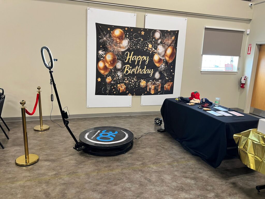 360 video booth with a happy birthday banner