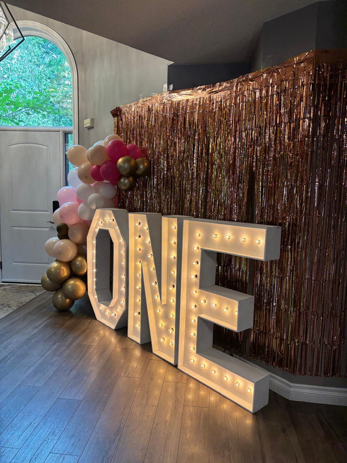 marquee letters, balloon garlands, and a backdrop for birthday celebration